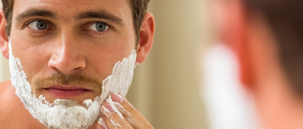 Man applying shaving foam